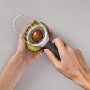 3-in-1 avocado slicer tool with knife and pit remover by Joseph Joseph in stone color