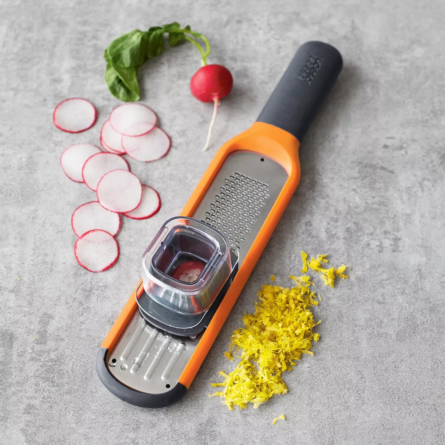 Joseph Joseph Handi-Grate 2-in-1 Mini Grater and Slicer in orange